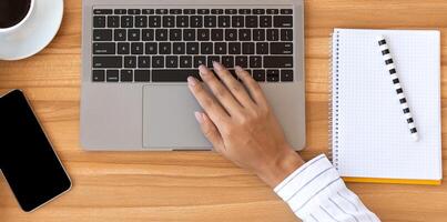 Marketing, Design. Overhead of office worker typing on pc with white display for mock up and holding cup of coffee photo