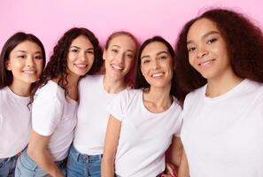 Group Of Multicultural Females Making Selfie Posing Together Smiling To Camera Over Pink Background In Studio. Females Friends Having Fun Taking Pictures Of Themselves photo