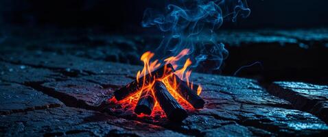 Dark Blue and Orange Embers Glowing on Rough Stone Surface at Night. photo