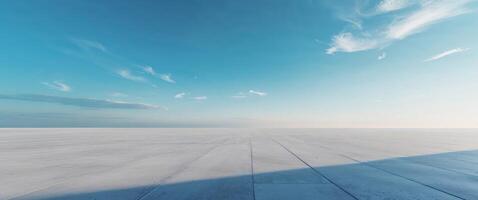 Dramatic scene with light highlighting a smooth concrete floor and sky photo