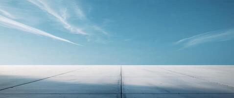 Dramatic scene with light highlighting a smooth concrete floor and sky. photo