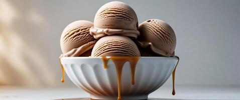 Scoops of Chocolate Ice Cream with Dripping Caramel Sauce. photo