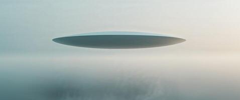 Mysterious disc shaped object over misty area. photo