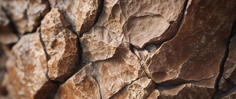 A close up of a rock wall with cracks photo