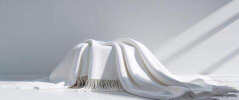 White Fringe Blanket on a Bright Surface Creating a Minimal Backdrop photo