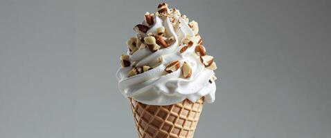 Delicious Vanilla Ice Cream Cone Topped with Chopped Nuts and Cream. photo