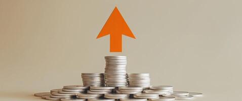 Orange Arrow Rising Above Stacks of White Coins on Pastel Background photo