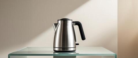 A compact travel kettle with a foldable handle sitting on a modern glass table. photo