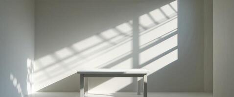 Sunlight casts shadows on a white wall and table. photo