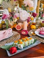 An Elegant Presentation of Sushi with Lovely Floral Accents photo