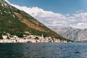 Excursion boat sails along the Bay of Kotor along the coast of Perast. Montenegro photo