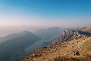 View from the mountain to the valley of the Bay of Kotor and mountains in the fog photo