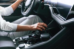 Close up view. Woman is sitting in a car ,and driving it photo