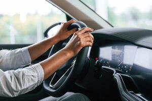 Close up view..., Woman is sitting in a car and driving it photo
