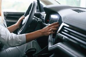 Close up view.. Woman is sitting in a car and driving it photo