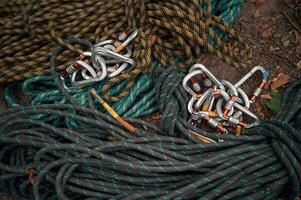 Bunch of ropes and carabiners are on the ground, conception of climbing photo
