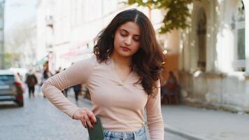 Indian young woman use smartphone loses receive bad message mail news loss fail on city street video