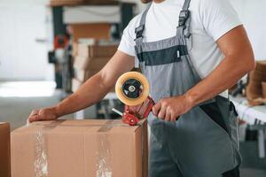 Packing, the product. Handsome man ,,is working at the factory of creating eco boxes photo