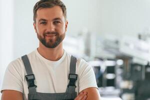 Close ,up portrait. Handsome man is working at the factory of creating eco boxes photo