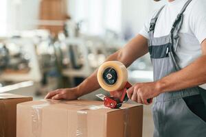 Close ,up ,,view. Man is working at the factory of creating eco boxes photo