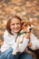 Young woman is with her dog in the park.,, photo