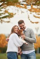 Smiling, having fun.., Lovely couple are with their cute dog outdoors photo