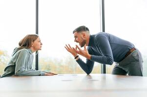 Man is ,screaming, at his girlfriend, conception of quarrel photo