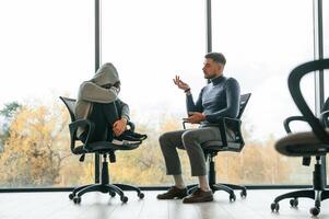 On the chairs ,,near window. Depressed woman is at an appointment with a psychologist photo
