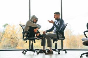 On the, chairs near window. Depressed woman is at an appointment with a psychologist photo