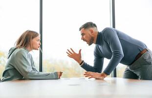 Man is ,screaming at his girlfriend, conception of quarrel photo
