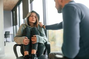 Depressed, woman is at an appointment with a psychologist photo