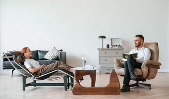 Side view. Woman is sitting in chair ,at, an appointment with a psychologist photo