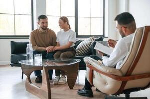 Man ,is writing ,notes. Couple at a psychologist's appointment photo