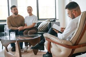 Man, is, writing notes. Couple at a psychologist's appointment photo