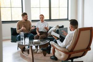 Man is writing notes. Couple at a ,psychologist's appointment photo