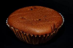 A cupcake is shown on a black background photo