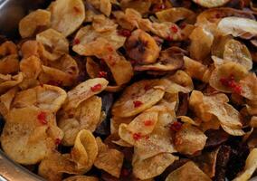 a bowl of chips with red pepper flakes photo