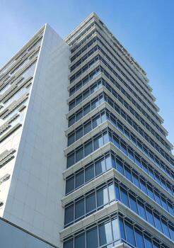 a tall building with a blue sky photo