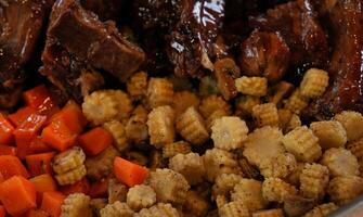 spare ribs with young corn and carrots photo