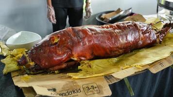 a large pig on a table with a knife photo