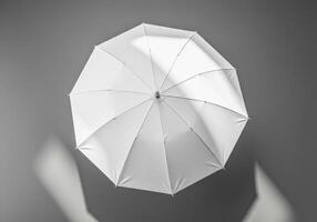 Minimalistic white umbrella top view on grey background for modern design and creativity photo
