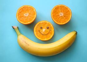 Happy Fruit Face with Oranges and Banana on Blue Background Photo