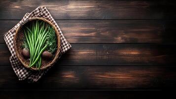 Green onions and potatoes in a basket on a wooden table top view photo