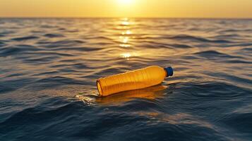 An orange plastic bottle floating in the ocean at sunset photo