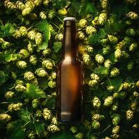 Glass beer bottle lying on fresh hops cones and leaves photo