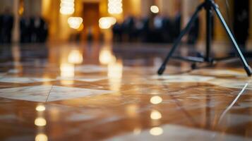 A detailed shot captures the intricacies of a marble floor reflecting the grandeur of the hall. In the foreground a pair of microphones stand ready for statements while blurred figure photo