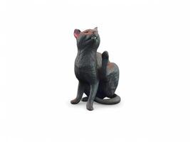A black cat statue sitting on a white background photo