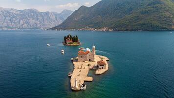 View of Island of Our Lady of the Rocks near the city of Perast in the Bay of Kotor in Montenegro. Aerial view of the island travel destination in the Adriatic Sea photo