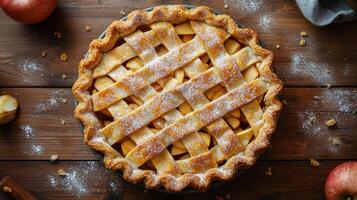 Baked apple pie with lattice crust. Golden brown dessert sprinkled with sugar on a rustic wooden table. Overhead view. photo