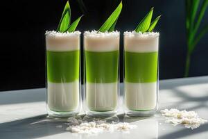 Captivating three-layer pandan coconut milk tea in double-walled glasses against a matte black backdrop photo
